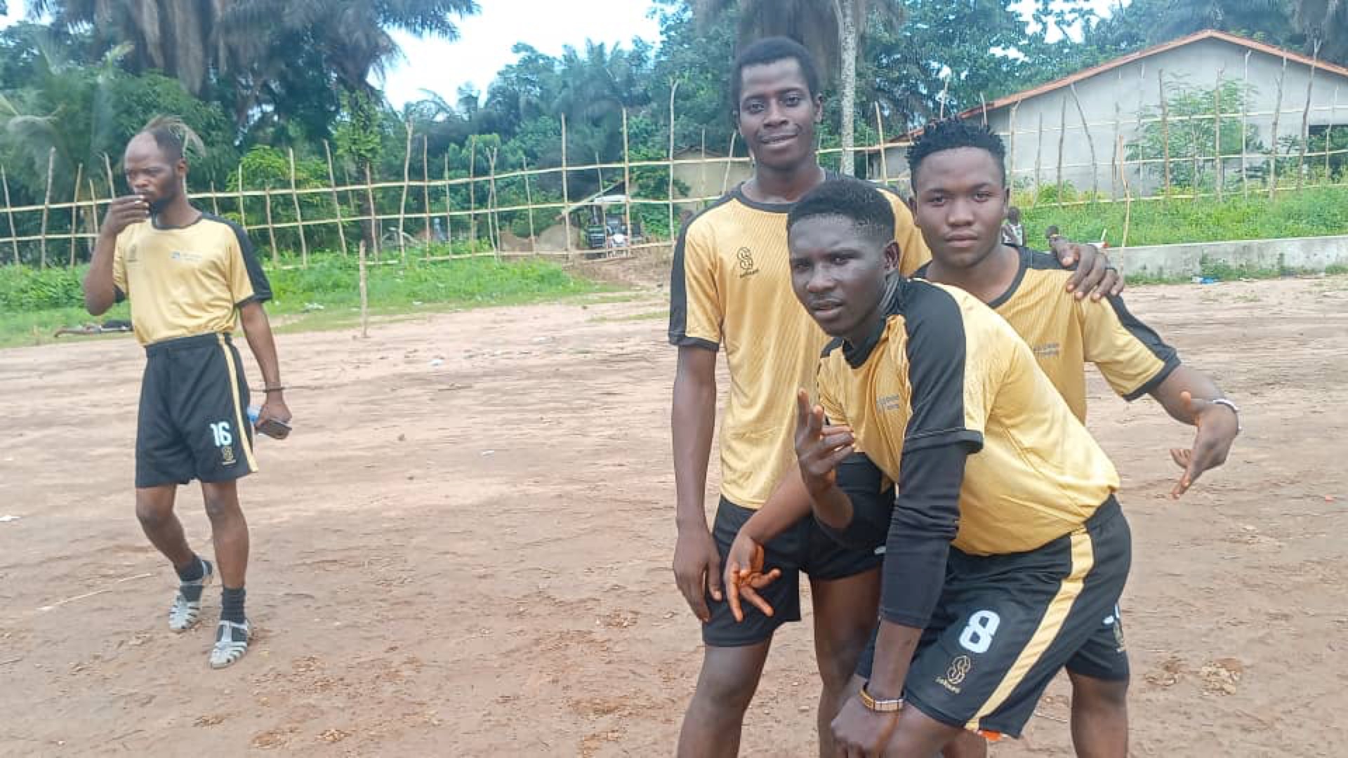 N5 staff in yellow jerseys celebrating on the football pitch