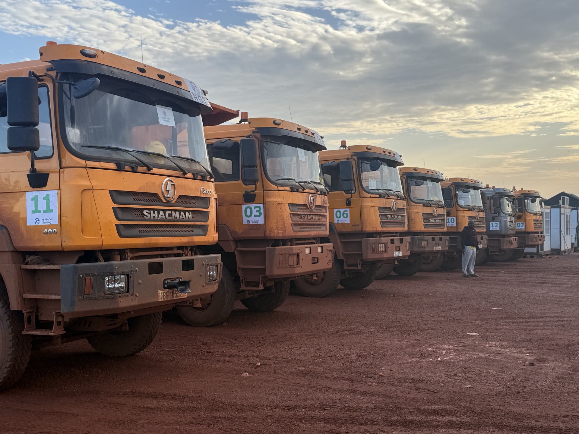 Two dump trucks parked side by side at the depot