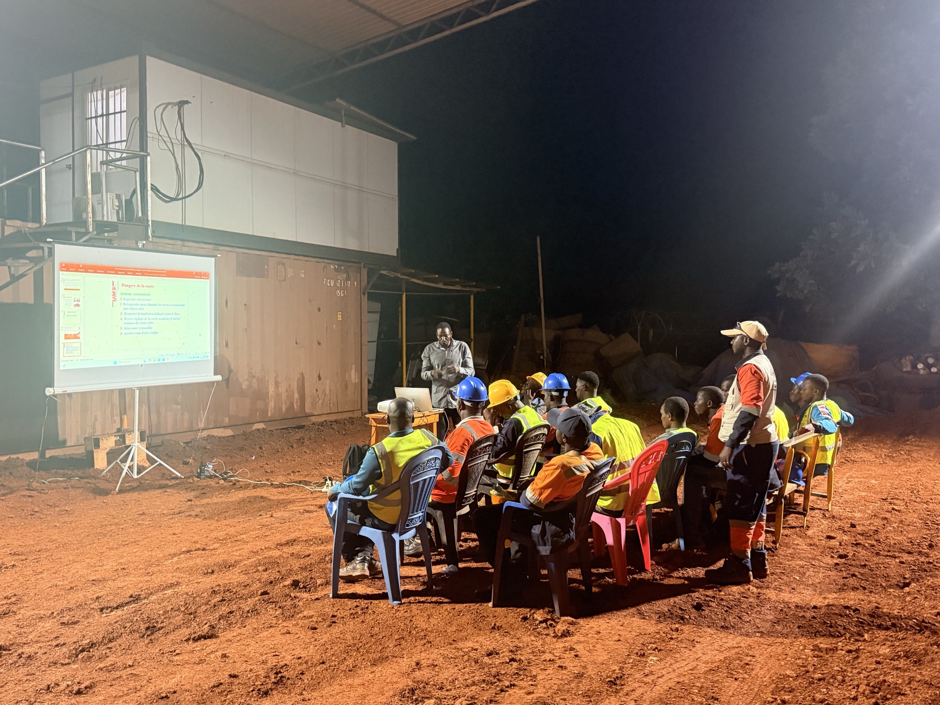 Large group of workers assembled on site for a safety meeting