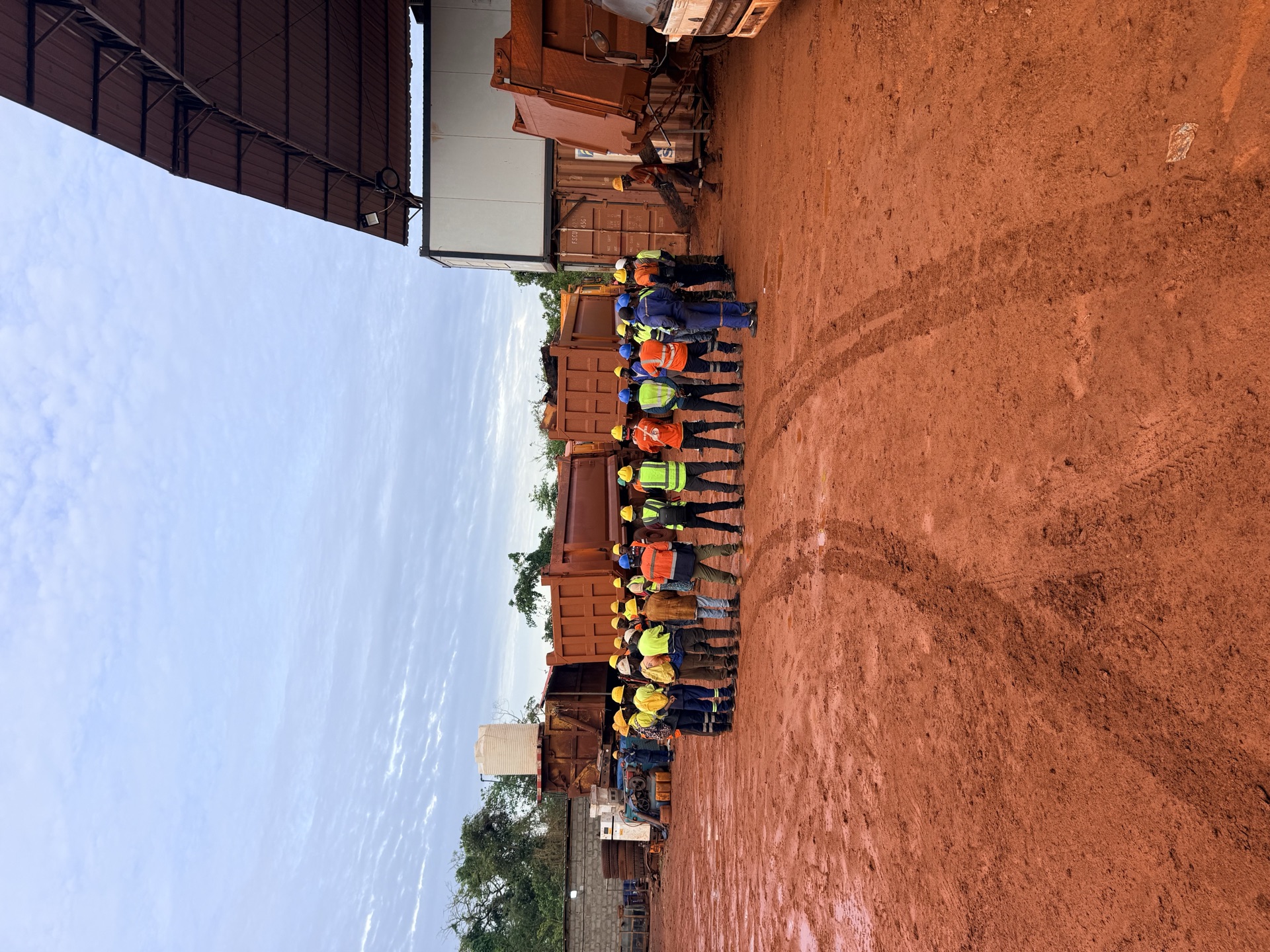 Workers gathered in the yard for a morning safety briefing